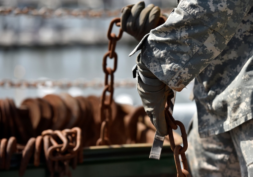 Specialist Andre Gross, a 226th Composite Supply Company mechanic, pulls a chain from a bucket to secure a Humvee during a Sealift Emergency Deployment Exercise at the Joint Base Charleston Federal Law Enforcement Training Center, May 10, 2016. The purpose of SEDREs is to test the abilities of Soldiers while loading and unloading equipment in a timely manner under stressful conditions. (U.S. Air Force Photo/Airman Megan Munoz) 