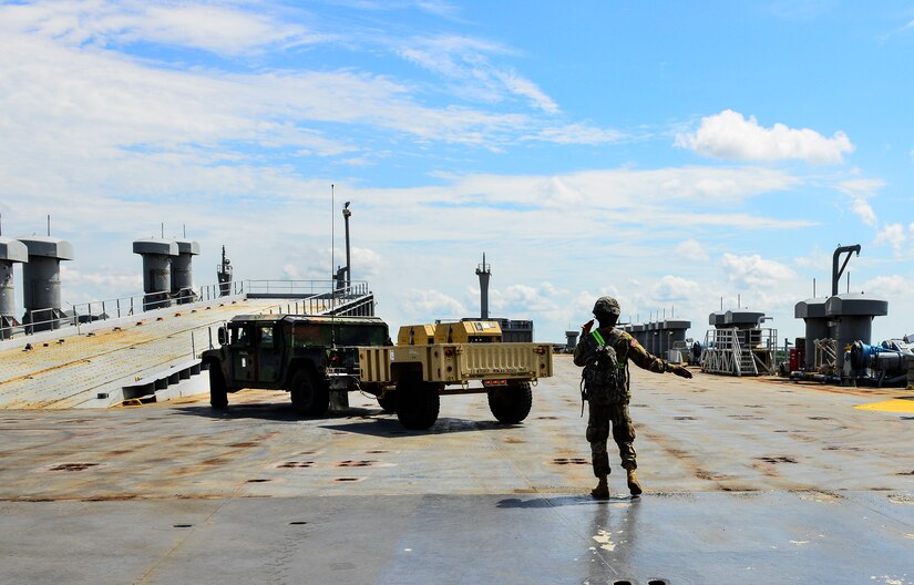 Private First Class Deandre Legacy, a 226th Composite Supply Company mechanic, directs a Humvee on the M/V Cape Decision (AKR-5054) ship during a Sealift Emergency Deployment Exercise at the Joint Base Charleston Federal Law Enforcement Training Center, May 10, 2016. More than 200 soldiers and 100 vehicles from Fort Stewart, Ga. convoyed to JB Charleston for a three-day Sealift Emergency Deployment Exercise. (U.S. Air Force Photo/Airman Megan Munoz)