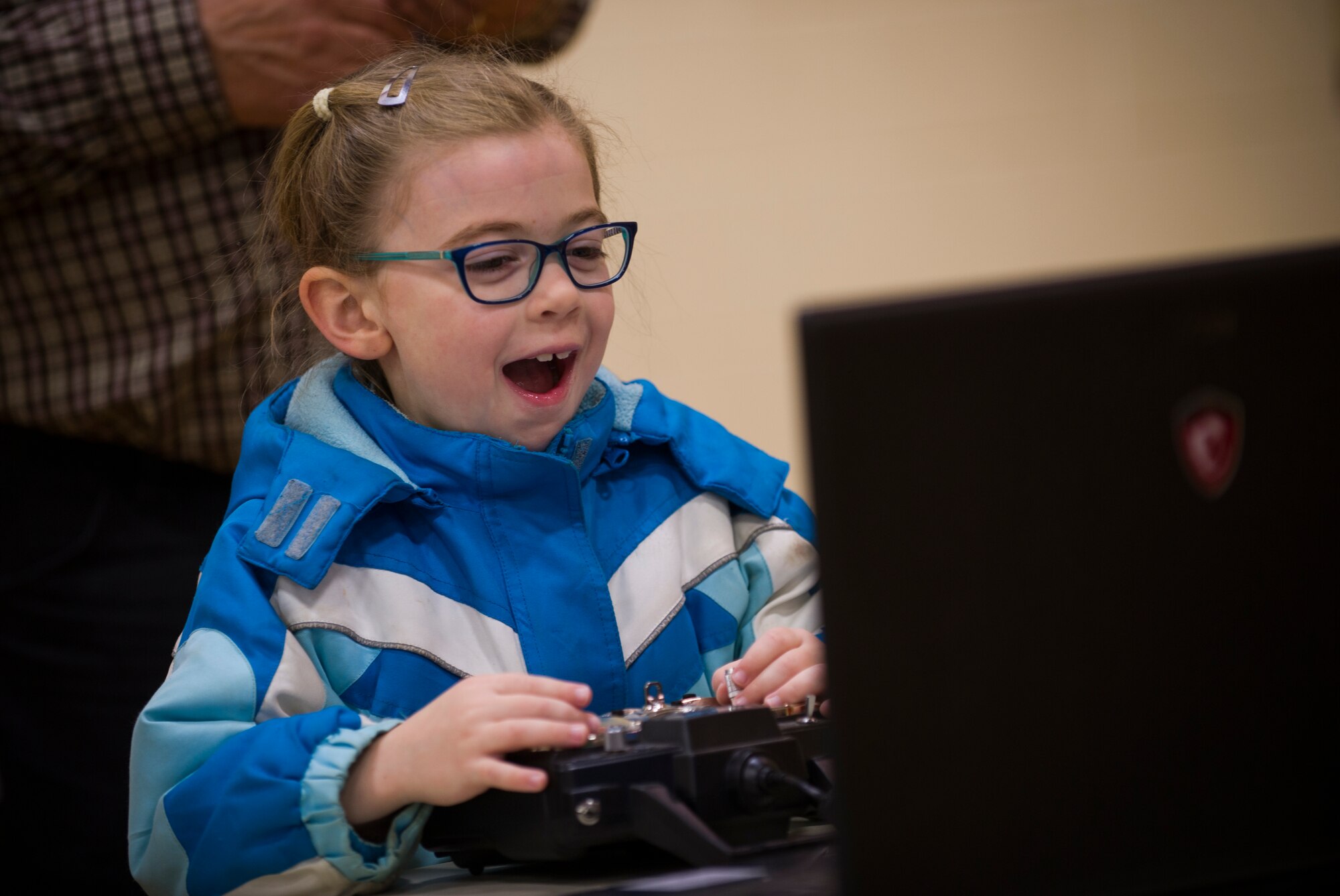 A child plays a flight simulator during the STEM Symposium at the Minot YMCA in Minot, N.D., May 14, 2016. The event, hosted by the 5th Bomb Wing Installation Diversity Council, featured interactive booths from units on base which taught them about the technology used in the military. (U.S. Air Force photo/Senior Airman Apryl Hall)