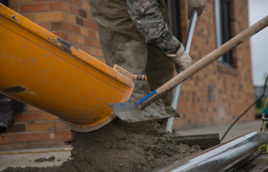 5th Civil Engineer Squadron pavement and equipment members pour concrete at Minot Air Force Base, N.D., May 12, 2016. The pavement and equipment shop or the “dirt boys,” do a variety of jobs around base including concrete, pavement and other repairs. (U.S. Air Force photo/Airman 1st Class Christian Sullivan)