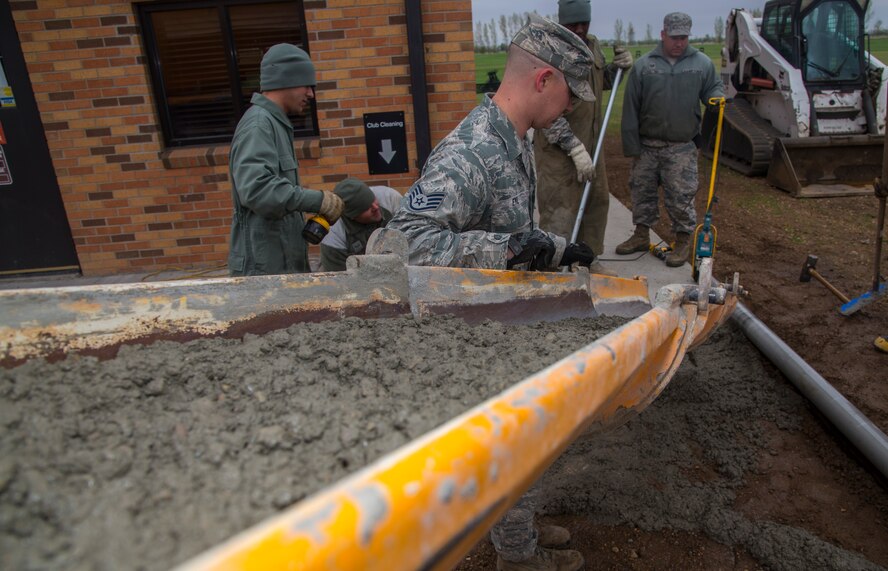 Staff Sgt. Zachary Eyl, 5th Civil Engineer Squadron pavement and equipment member, pours concrete at Minot Air Force Base, N.D., May 12, 2016. The pavement and equipment shop or the “dirt boys,” do a variety of jobs around base including concrete, pavement and other repairs. (U.S. Air Force photo/Airman 1st Class Christian Sullivan)