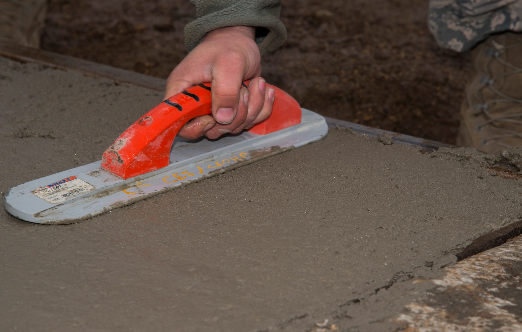 A 5th Civil Engineer Squadron pavement and equipment member flattens concrete at Minot Air Force Base, N.D., May 12, 2016. The pavement and equipment shop or the “dirt boys,” do a variety of jobs around base including concrete, pavement and other repairs. (U.S. Air Force photo/Airman 1st Class Christian Sullivan)