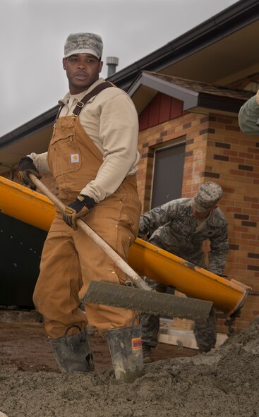 A 5th Civil Engineer Squadron pavement and equipment member flattens concrete at Minot Air Force Base, N.D., May 12, 2016. The pavement and equipment shop or the “dirt boys,” do a variety of jobs around base including concrete, pavement and other repairs. (U.S. Air Force photo/Airman 1st Class Christian Sullivan)