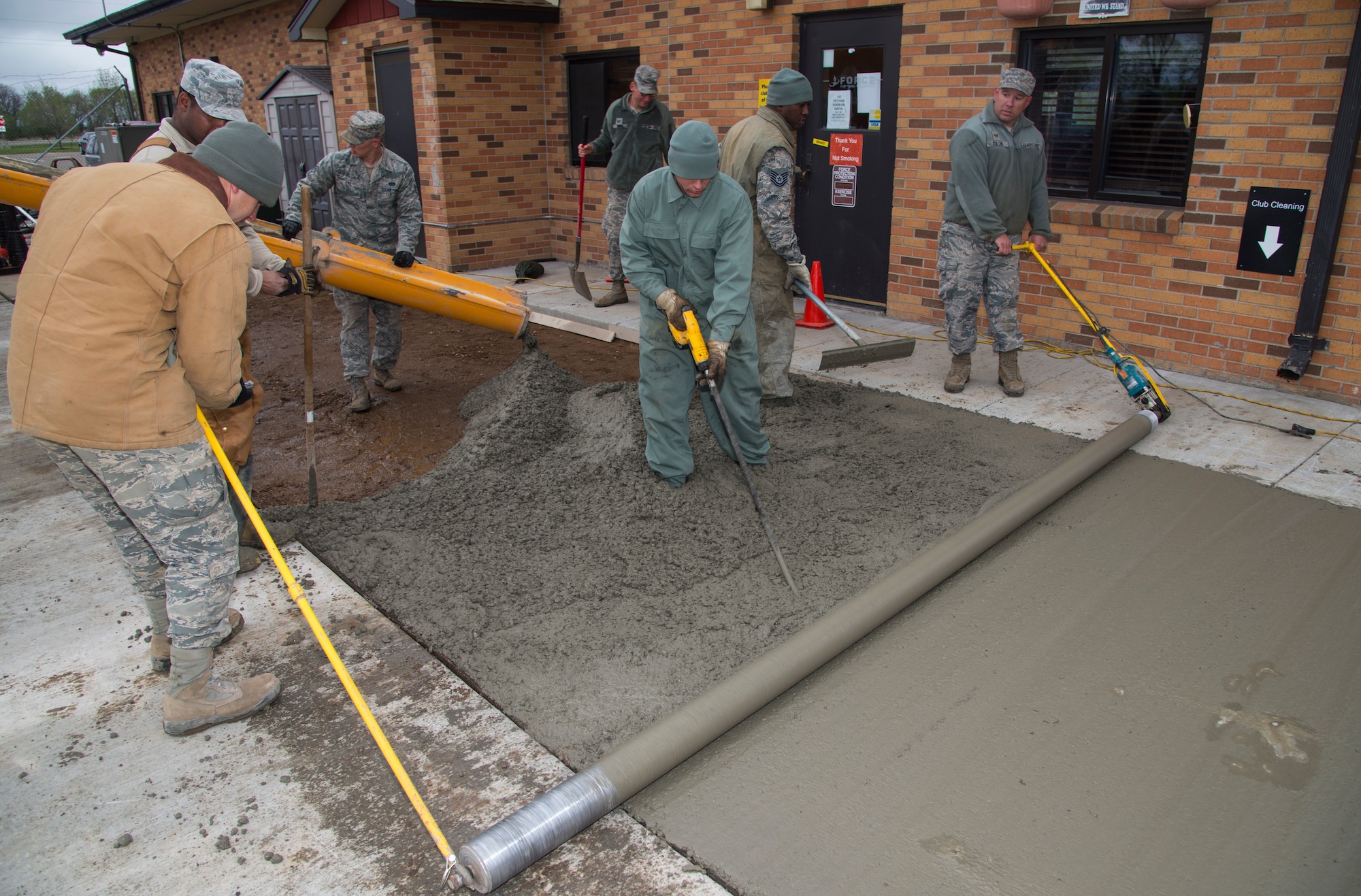 5th Civil Engineer Squadron pavement and equipment members flatten and pour concrete at Minot Air Force Base, N.D., May 12, 2016. The pavement and equipment shop or the “dirt boys,” do a variety of jobs around base including concrete, pavement and other repairs. (U.S. Air Force photo/Airman 1st Class Christian Sullivan)