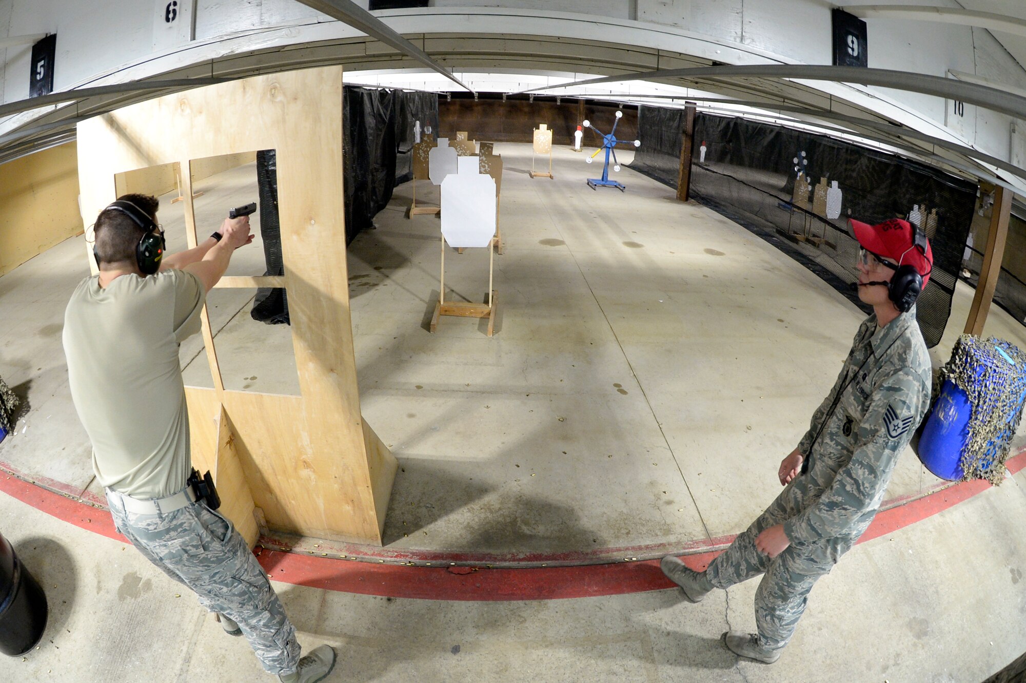 1st Lt. Sterling Broadhead, 419th Logistics Readiness Squadron, participates in a shooting competition May 10 at Hill Air Force Base’s firing range. Staff Sgt. Cody Albritton, 75th Security Forces Squadron, judged the firing competition and ensured range safety. The event was hosted by the 75th Security Forces Combat Arms Section as part of National Police Week activities. (U.S. Air Force photo by Todd Cromar)