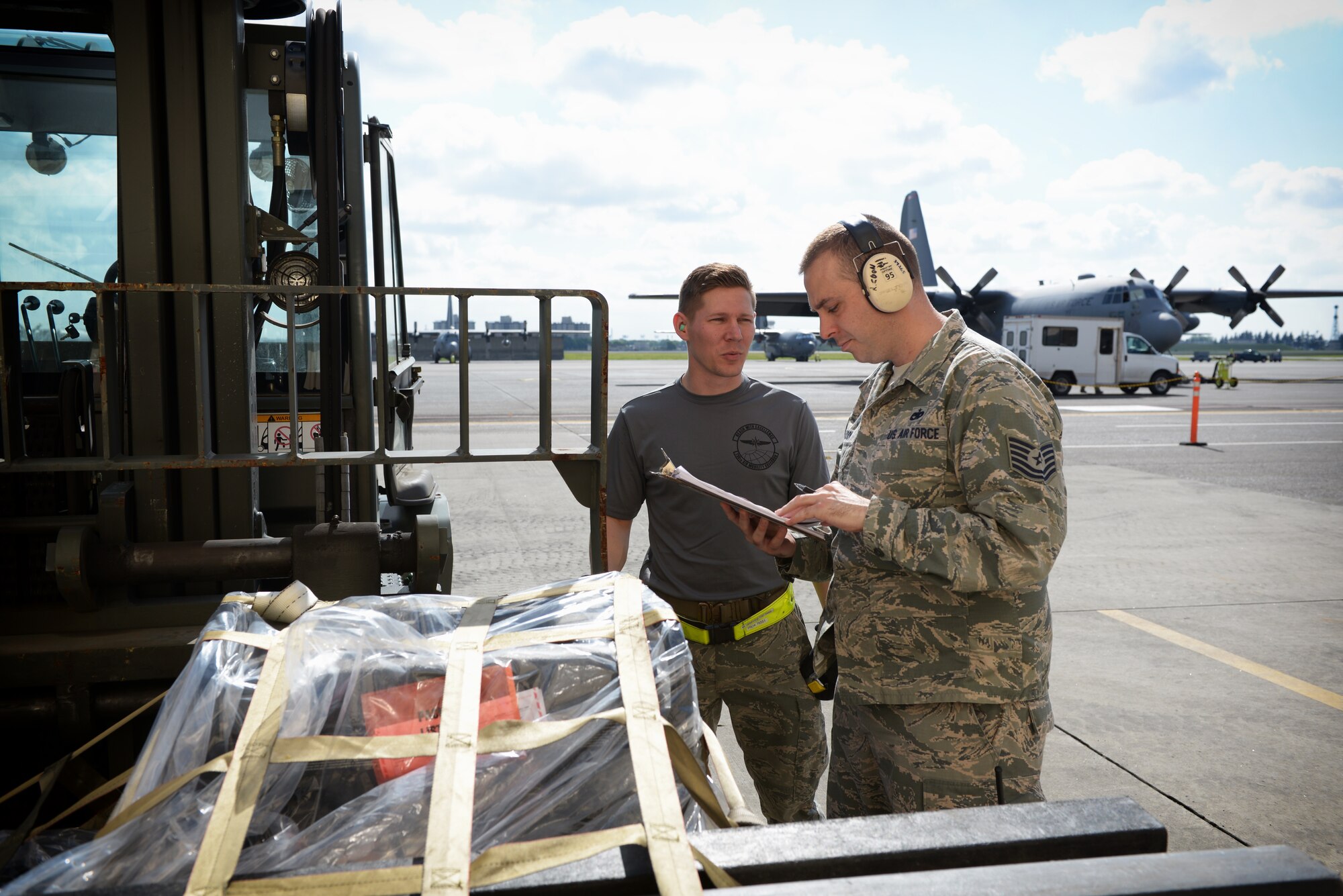 Airmen inspect a cargo pallet before it is loaded onto a C-130 Hercules at Yokota Air
Base, Japan, May 13, 2016. The 374th Airlift Wing and partner units practiced their
humanitarian aid and disaster relief capabilities throughout the week. (U.S. Air Force
photo by Staff Sgt. Cody H. Ramirez/Released)