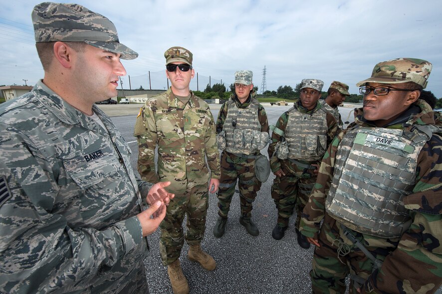 U.S. Air Force Staff Sgt. James Baker, 18th Civil Engineer Squadron training NCO in charge of the Readiness and Emergency Management Flight, discusses decontamination procedures with U.S. Army Soldiers from the 1-1 Air Defense Artillery Headquarters and Headquarters Battalion during a joint exercise May 12, 2016, at Kadena Air Base, Japan. The purpose of the U.S. military on Okinawa is to strengthen regional alliances, protect the Okinawan populace from potential threats and defend the U.S. and allied nations’ interests in the area. In order to maintain joint readiness, the Air Force and Army from Team Kadena conducted a joint decontamination exercise, emphasizing each unit’s techniques and procedures to boost interoperability. (U.S. Air Force photo by Staff Sgt. Maeson L. Elleman)