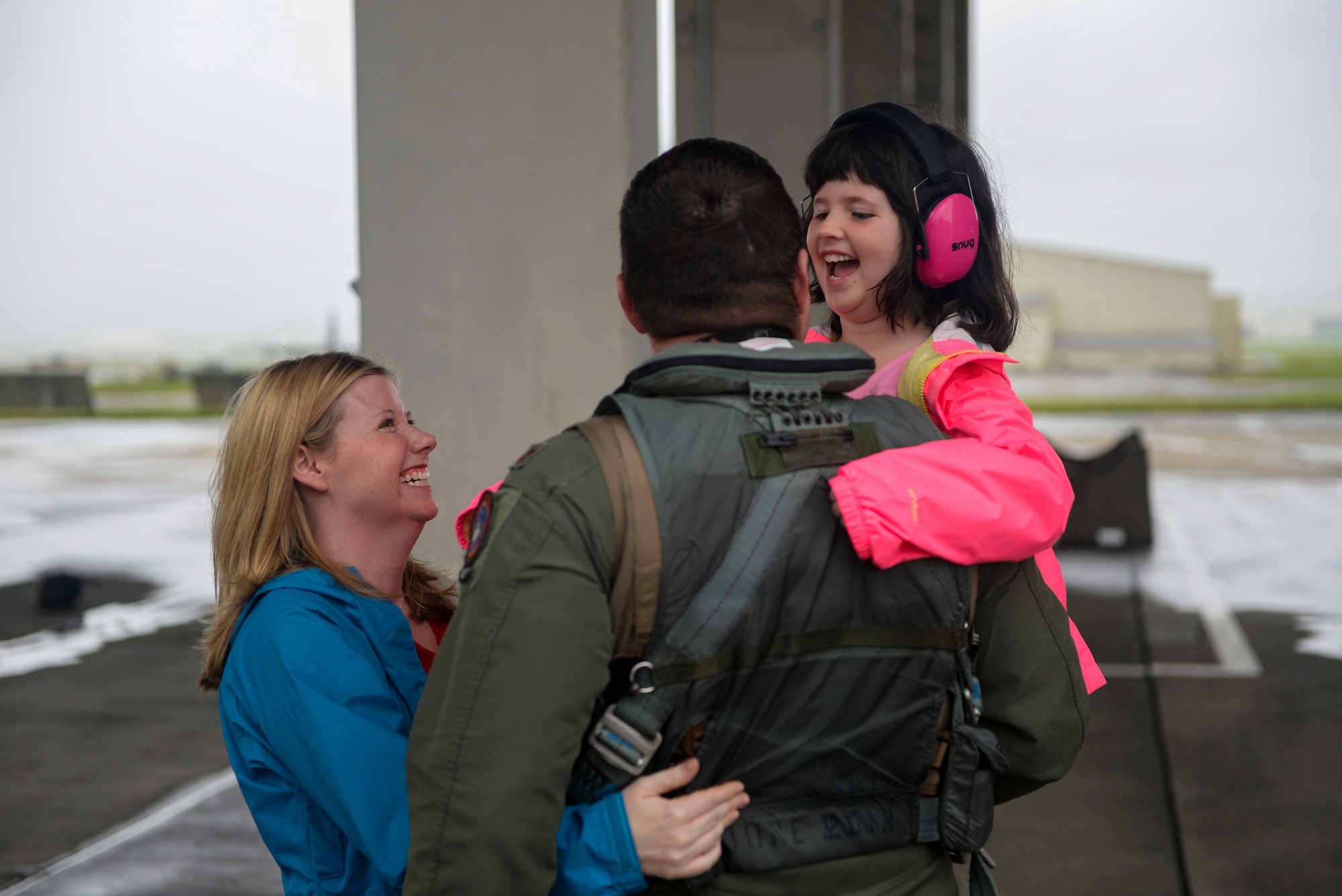 U.S. Air Force Maj. Ryan Corrigan, 67th Fighter Squadron pilot, embraces his family May 16, 2016, after returning to Kadena Air Base, Japan. Pilots and maintainers from the 67th FS and Maintenance Squadron returned home after a six-week temporary duty assignment at the Weapons Systems Evaluation Program at Tyndall Air Force Base, Florida, and exercise RED FLAG-Alaska at Eielson Air Force Base. The F-15C Eagle has electronic systems and weaponry to detect, acquire, track and attack enemy aircraft while operating in friendly or enemy-controlled airspace. (U.S. Air Force photo by Senior Airman Stephen G. Eigel)