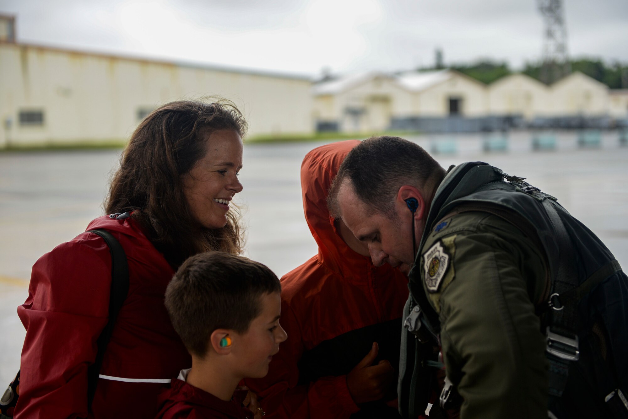 U.S. Air Force Lt. Col. James McFarland, 67th Fighter Squadron commander, embraces his family May 16, 2016, after returning to Kadena Air Base, Japan. Pilots from the 67th Fighter Squadron returned home after a six-week temporary duty assignment at the Weapons Systems Evaluation Program at Tyndall Air Force Base, Florida, and exercise RED FLAG-Alaska at Eielson Air Force Base. Family members and friends wore an article of red clothing to show support and pride for the squadron during the homecoming. (U.S. Air Force photo by Senior Airman Stephen G. Eigel)