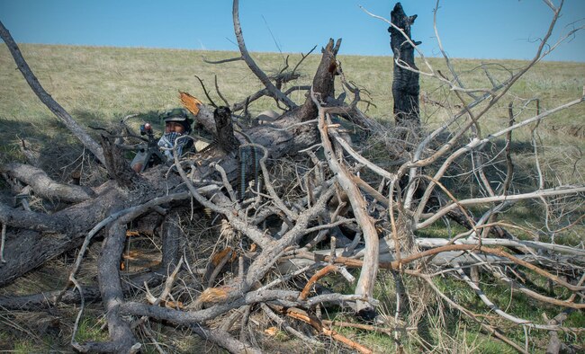 Senior Airman Kevin Kiner, 921st Contingency Response Squadron defender, attempts to conceal himself and his M240 machine gun in preparation for an a missile convoy attack scenario during exercise Road Warrior at Camp Guernsey, Wyo., May 4, 2016. The 621st CRW Airmen played the opposing force for the Global Strike Command exercise, which evaluates tactics, techniques, and procedures used to secure nuclear–capable weapons and critical intercontinental ballistic missile components during convoy operations. (U.S. Air Force photo by Staff Sgt. Robert Hicks/Released)