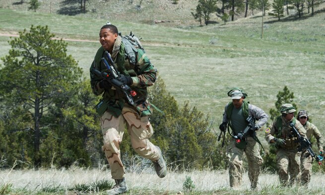 The 621st Contingency Response Wing breach team, races up the side of a hill during an attack scenario for exercise Road Warrior at Camp Guernsey, Wyo., May 3, 2016. The 621st CRW Airmen played the opposing force for the Global Strike Command exercise, which evaluates tactics, techniques, and procedures used to secure nuclear–capable weapons and critical intercontinental ballistic missile components during convoy operations. (U.S. Air Force photo by Staff Sgt. Robert Hicks/Released)