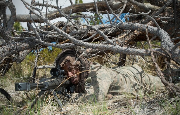 Senior Airman Gerald Styles, 921st Contingency Response Squadron sniper, looks through the scope of an M-107 sniper rifle during a missile convoy attack scenario for exercise Road Warrior at Camp Guernsey, Wyo., May 3, 2016. The 621st CRW Airmen played the opposing force for the Global Strike Command exercise, which evaluates tactics, techniques, and procedures used to secure nuclear–capable weapons and critical intercontinental ballistic missile components during convoy operations. (U.S. Air Force photo by Staff Sgt. Robert Hicks/Released)