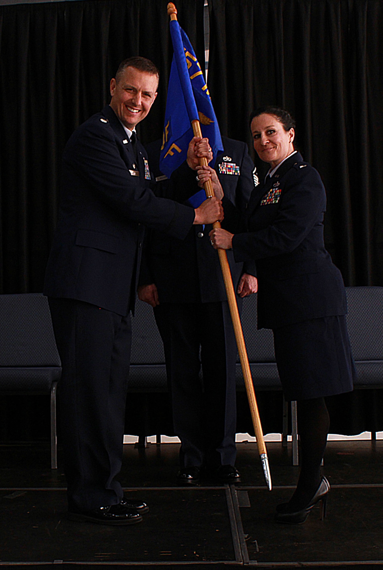 U.S. Air Force 1st Lt. Melinda Fuller accepts the 157th Maintenance Operations Flight guidon from 157th Maintenance Group Commander, Lt. Col. Paul Kell during a change of command ceremony, Pease Air National Guard Base, N.H. May 14, 2016. (U.S. Air National Guard photo by Staff Sgt. Kayla Rorick)