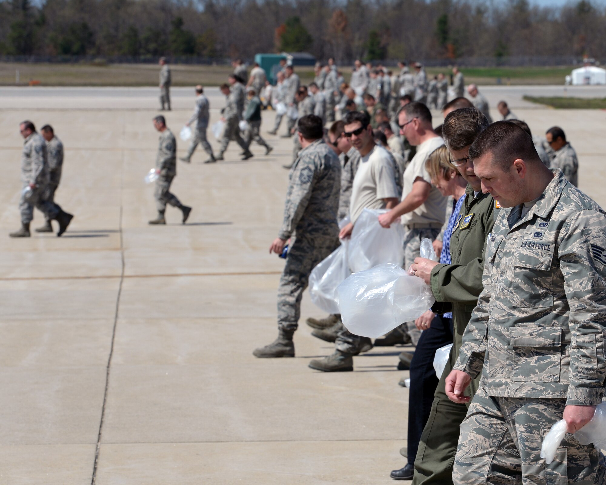 Members of the 157th Air Refueling Wing participate in a quarterly foreign object damage (FOD) walk, Pease Air National Guard Base, N.H., May 11, 2016. FOD debris has the potential to damage aircraft during critical phases of flight, which can lead to catastrophic loss of life and airframe, and at the very least increased maintenance and operating costs.  (U.S. Air National Guard photo by Staff Sgt. Curtis J. Lenz)