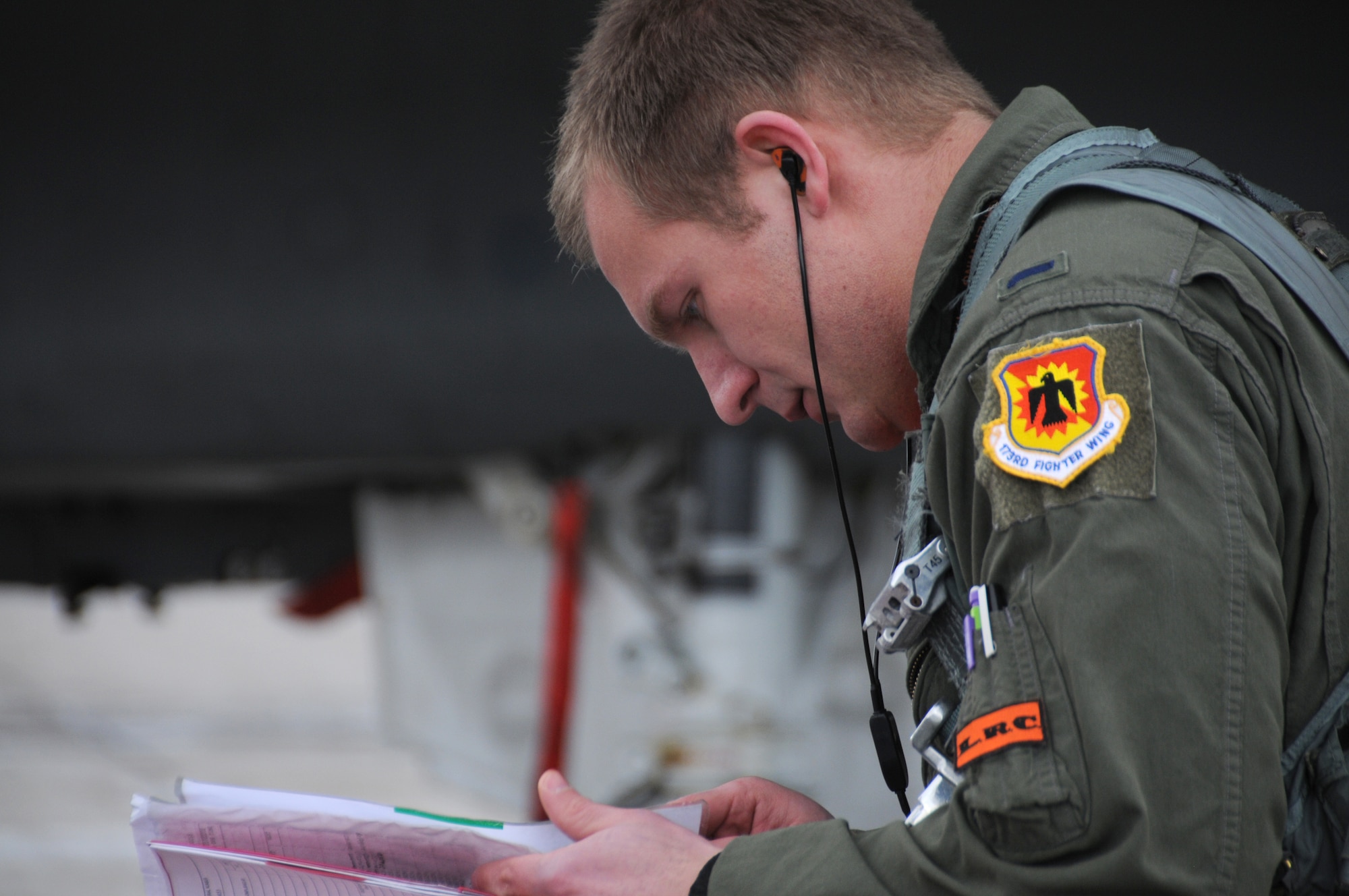 1st Lt. Brock McGehee, Class 16-ABK, looks at the paperwork showing his jet is ready for the mission, in this case it’s to practice basic fighter maneuvers with an instructor pilot in the back seat of this D-model F-15, March 11, 2016. Class 16-ABK has crossed the half-way mark for their introduction to the airframe and is rapidly moving into the heart of the training—learning to employ the Eagle as the weapons platform it is designed to be. (U.S. Air National Guard photo by Tech. Sgt. Jefferson Thompson)