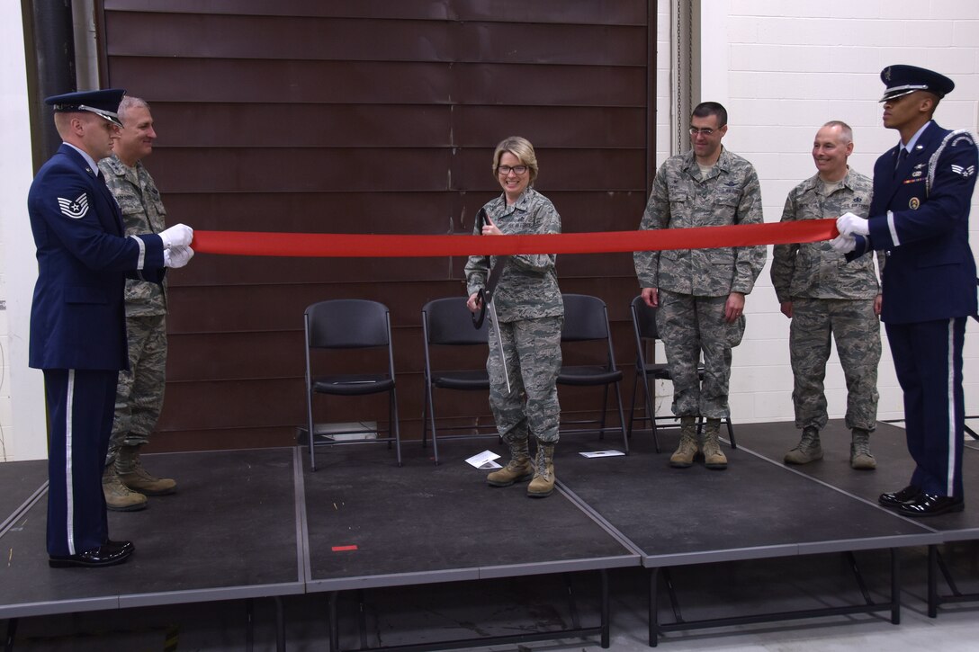 Ohio Air National Guard Colonel Rebecca O’Connor, Commander 178th Intelligence Surveillance and Reconnaissance Group, cuts a ribbon, while Major General Stephen Markovich, the commander of the Ohio Air National Guard, Colonel Brian Davis, 178th Wing Commander, and Chief Master Sergeant Philip Smith, Ohio National Guard State Command Chief, watch at Springfield, Ohio May 14, 2016.  O’Connor cut the ribbon during the ribbon cutting ceremony to introduce the new building to the wing and thank those involved with making this state-of-the-art facility a reality.