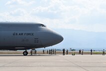 Members of the 612th Air Base Squadron prepare to board a C-5M Super Galaxy from Dover Air Force Base, Del., after its arrival to Soto Cano Air Base, Honduras, May 13, 2016. Through the Denton Program, the C-5 delivered approximately 85,000 pounds of rice and beans which is to be distributed to people in the Yoro Department of Honduras by a local non-governmental organization. (U.S. Air Force photo by Staff Sgt. Siuta B. Ika)