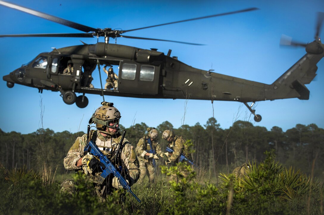 An airman provides security during fast-rope training from an Army UH-60 Black Hawk helicopter as part of Emerald Warrior 16 at Hurlburt Field, Fla., May 4, 2016. The airmen are special tactics squadron assigned to 24th Special Operations Wing. The training prepares special operations forces to respond to real and emerging worldwide threats. Air Force photo by Senior Airman Trevor T. McBride
