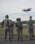 U.S. Airmen assigned to the 354th Medical Group (MDG) watch as an EA-18G Growler assigned to Electronic Attack Squadron 137, Naval Air Station Whidbey Island, Wa., launches for a morning sortie during RED FLAG-Alaska 16-1, on May 11, 2015, Eielson Air Force Base, Alaska. Members of the 354 MDG were provided the opportunity to watch a launch during RF-A 16-1 in order to further understand a different aspect of the wing’s mission they support daily. (U.S. Air Force photo by 1Lt Elias Zani/Released)