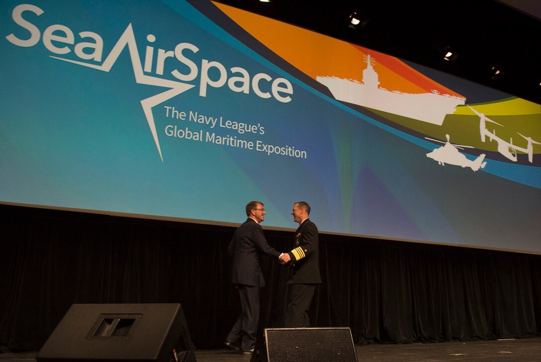 Chief of Naval Operations Adm. John M. Richardson welcomes Defense Secretary Ash Carter as the guest speaker during the Navy League's Sea-Air-Space Exposition at the Gaylord National Convention Center in National Harbor, Md., May 17, 2016. DoD photo by Air Force Senior Master Sgt. Adrian Cadiz
