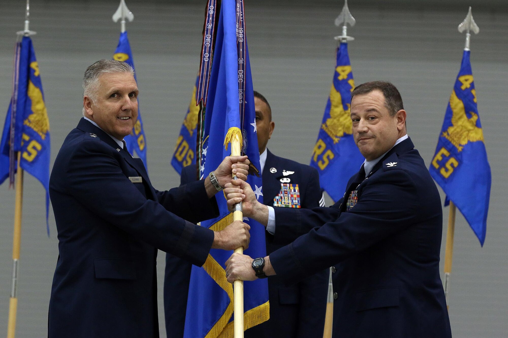 Maj. Gen. John Flournoy, 4th Air Force commander, passes the guidon to Col. Adam Willis incoming 445th Airlift Wing commander, during the 445th Airlift Wing change of command ceremony May 15, 2016. Prior to his arrival to the 445th, Colonel Willis served as the commander of the 908th Airlift Wing, Maxwell Air Force Base, Alabama. (U.S. Air Force photo/Tech. Sgt. Patrick O'Reilly)