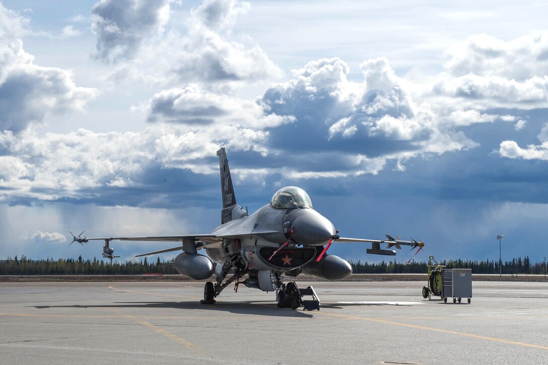 An Air Force F-16 Fighting Falcon aircraft sits on the tarmac following maintenance before the next sortie mission during Red Flag 16-1 at Eielson Air Force Base, Alaska, May 4, 2016. The airmen are maintainers assigned to the 18th Aggressor Squadron charged with keeping the aircraft ready for more than 500 flying hours during Red Flag 16-1. Air Force photo by Staff Sgt. Shawn Nickel