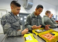 Tech. Sgt. Roscoe Tamondong, 86th Maintenance Group NCO in-charge instructor element, oversees Airman 1st Class Zachary Johnson, 86th Maintenance Squadron crew chief, as he checks out tools to check tire pressures on the C-130J Super Hercules May 17, 2016, at Ramstein Air Base, Germany. Tamondong has been a maintenance qualification training program instructor for over a year, teaching more than 50 students annually. (U.S. Air Force photo/Staff Sgt. Leslie Keopka)
