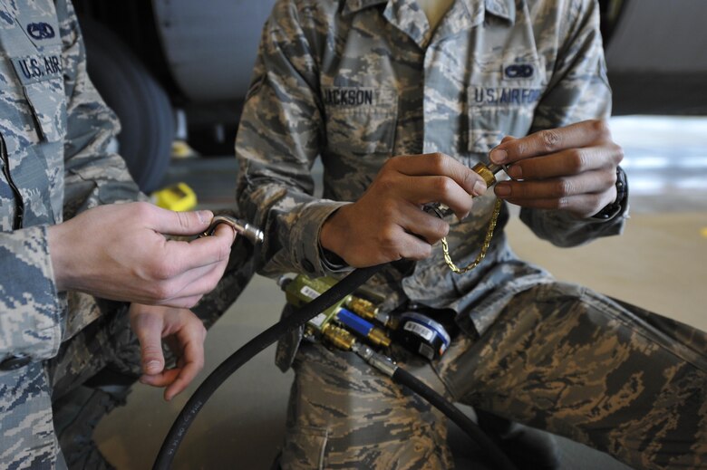 Airman 1st Class Zachary Jackson, 86th Maintenance Squadron crew chief apprentice (right), prepares the necessary tools to read tire pressures on a C-130J Super Hercules during a training course May 17, 2016 at Ramstein Air Base, Germany. Jackson has been at Ramstein for approximately 3 months and is attending the crew chief training course to fulfill his upgrade training requirements. (U.S. Air Force photo/Staff Sgt. Leslie Keopka)