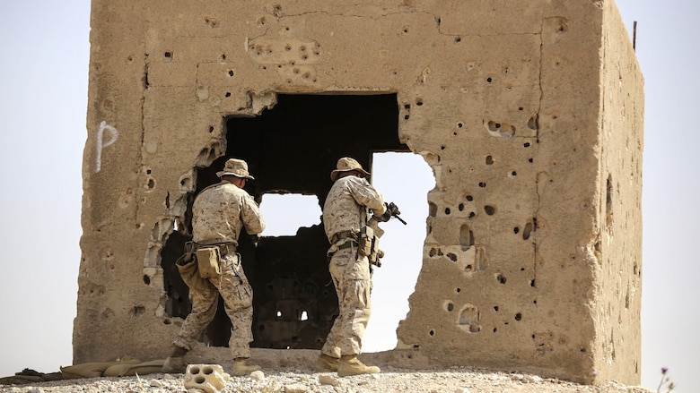 Marines with 1st Battalion, 2nd Marine Regiment, 2nd Marine Division secure an objective during a squad-level exercise in Al Quweyrah, Jordan, May 14, 2016. Machine gunners and assaultmen occupied support-by-fire positions to assist squads as they advanced on lower ground. 