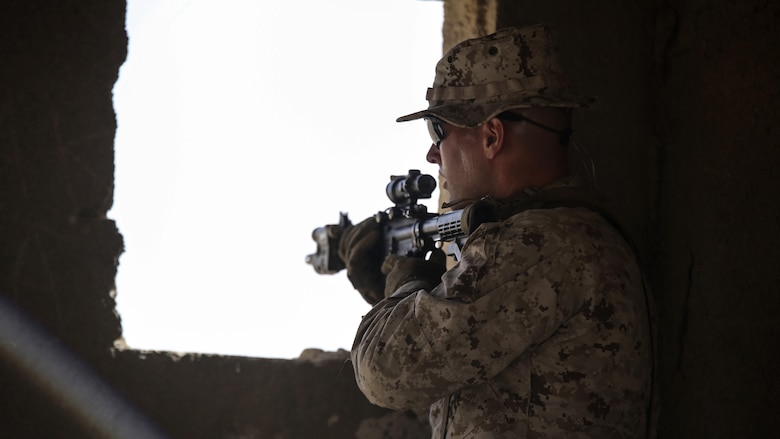 A Marine with 1st Battalion, 2nd Marine Regiment, 2nd Marine Division occupies an objective uring a squad-level exercise in Al Quweyrah, Jordan, May 14, 2016. During the exercise, platoon commanders relayed combat scenarios to squad leaders, delegating tactical decision-making down to the squad level. 