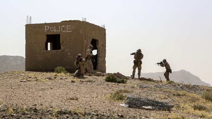 Marines with 1st Battalion, 2nd Marine Regiment, 2nd Marine Division, secure an objective during a squad-level exercise in Al Quweyrah, Jordan, May 14, 2016. Machine gunners and assaultmen occupied support-by-fire positions to assist squads as they advanced on lower ground. 
