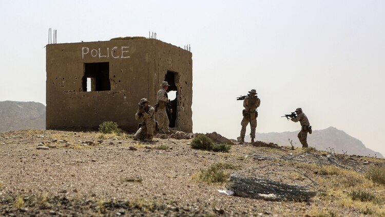 Marines with 1st Battalion, 2nd Marine Regiment, 2nd Marine Division, secure an objective during a squad-level exercise in Al Quweyrah, Jordan, May 14, 2016. Machine gunners and assaultmen occupied support-by-fire positions to assist squads as they advanced on lower ground. 