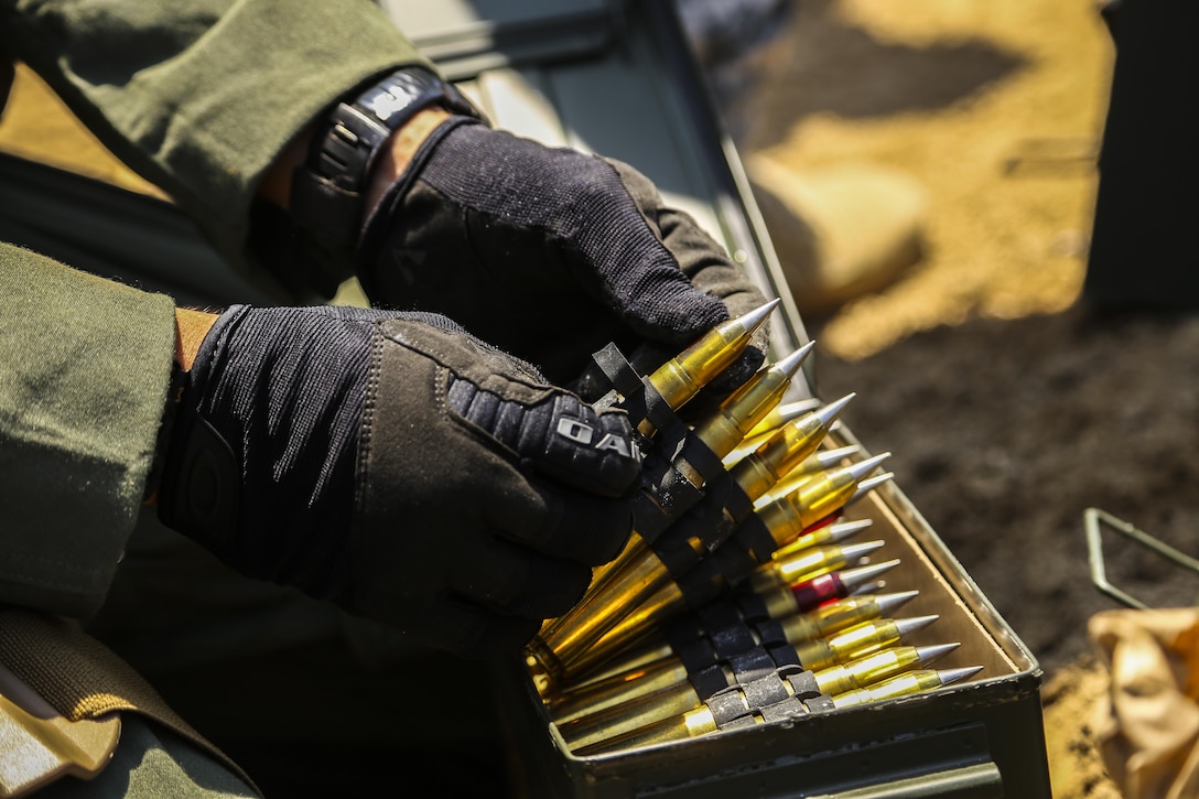 A Marine Explosive Ordnance Disposal technician prepares to stage .50 Caliber rounds to perform burning operations during Korea EOD Exercise May 14, 2016, at Camp Rodriguez Live Fire Complex, South Korea. The Marines ignited repellent charges to train for disposing of ammunition that can no longer be used. The Marines are with 3rd EOD Company, 9th Engineer Support Battalion, 3rd Marine Logistics Group, III Marine Expeditionary Force. (U.S. Marine Corps photo by Cpl. Isaac Ibarra/Released)