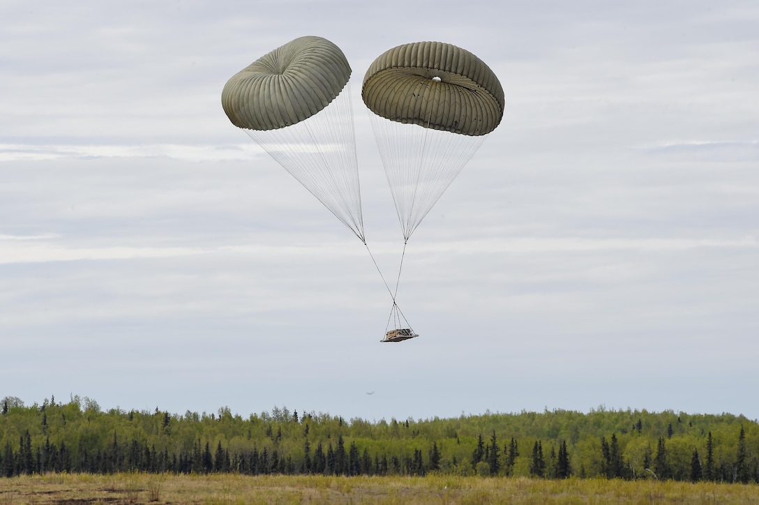 A heavy pallet descends over Malemute drop zone during Red Flag Alaska 16-1 at Joint Base Elmendorf-Richardson, May 11, 2016. The pallet was dropped from an Air Force MC-130J Commando II aircraft, assigned to the 17th Special Operations Squadron, deployed from Kadena Air Base, Okinawa, Japan. Air Force photo by Alejandro Pena