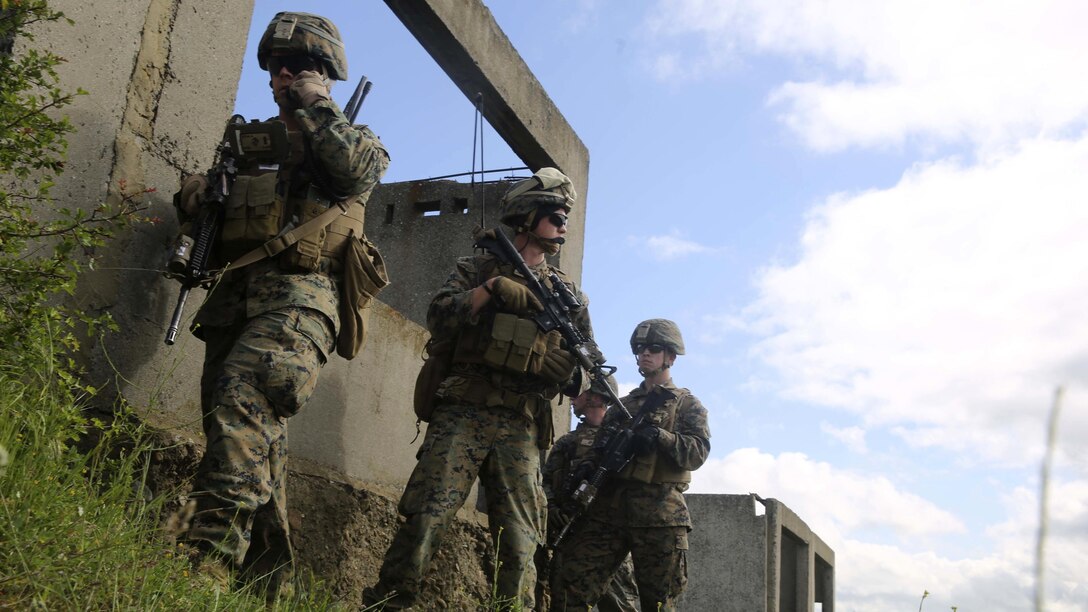 U.S. Marines with Bravo Company, Special Purpose Marine Air-Ground Task Force Crisis Response-Africa, pause and establish communication for the assault on Military Operations on Urban Terrain Town during Platinum Lion 16-3 at the Novo Selo Training Area, Bulgaria, May 10, 2016. During the exercise, Allies from the United States and four partner nations conducted platoon-level mechanized tactics in order to develop proficiency in fire and maneuver. 