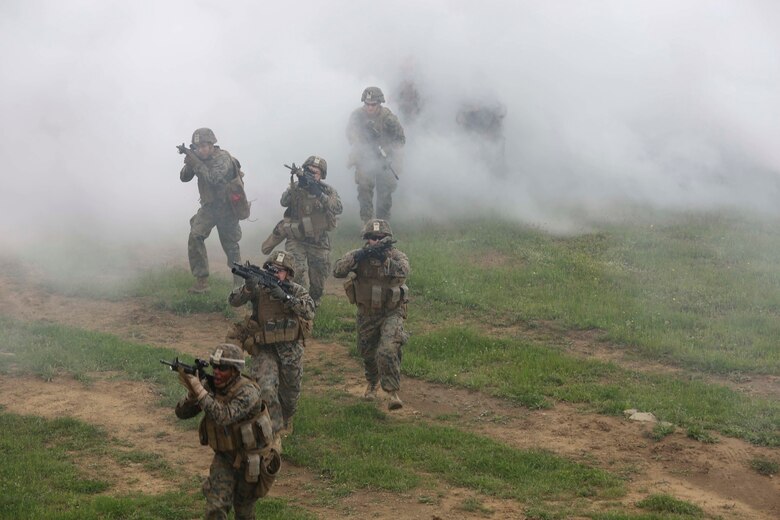 U.S. Marines with Bravo Company, Special Purpose Marine Air-Ground Task Force Crisis Response-Africa, exit the smokescreen and proceed to their final objective for the assault on Military Operations on Urban Terrain Town during Platinum Lion 16-3 at the Novo Selo Training Area, Bulgaria, May 10, 2016. During the exercise, Allies from the United States and four partner nations conducted platoon-level mechanized tactics in order to develop proficiency in fire and maneuver. 