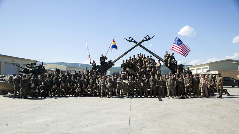 U.S. Marines with Black Sea Rotational Force and Special Purpose Marine Air-Ground Task Force Crisis Response-Africa, pose for a group photo with partner nations in attendance for the closing ceremony to conclude Platinum Lion 16-3 at the Novo Selo Training Area, Bulgaria, May 14, 2016. During the exercise, Allies from the United States and four partner nations conducted platoon-level mechanized tactics in order to develop proficiency in fire and maneuver.