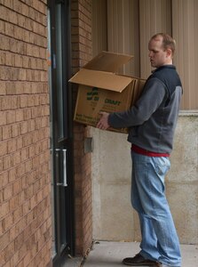 Capt. Andrew Jones, human resources officer 11th/100th Military Intelligence Battalion, 100th Training Division, arrives at the La Crosse Wis., YWCA with 50 items of clothing donated by Soldiers assigned to the 11th/100th Military Intelligence Battalion, 100th Training Division. Jones delivered the items May 12 2016.