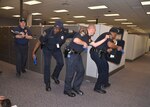 Defense Logistics Agency Installation Support at Richmond police officers respond to a simulated active shooter during an emergency response exercise held on Defense Supply Center Richmond, Virginia, May 2014. DLA will hold another active shooter exercise May 24, 2016. 
