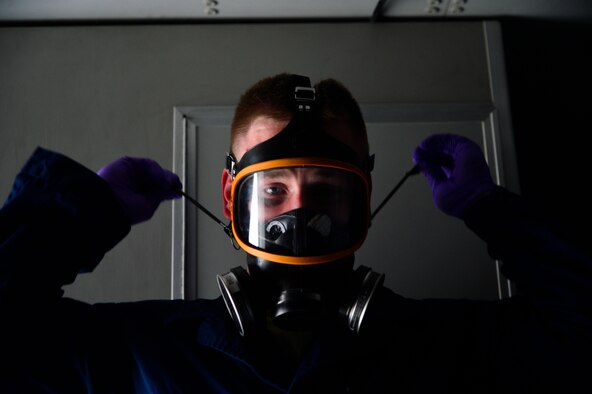 Staff Sgt. Daniel Fink, a 436th Civil Engineer Squadron Pest Management supervisor, dons a respirator before treating a C-17 Globemaster III for the Zika virus May 11, 2016, at Dover Air Force Base, Del. All U.S. aircraft are now required to be treated for Zika before flying into or through Italy. (U.S. Air Force photo/Senior Airman William Johnson)