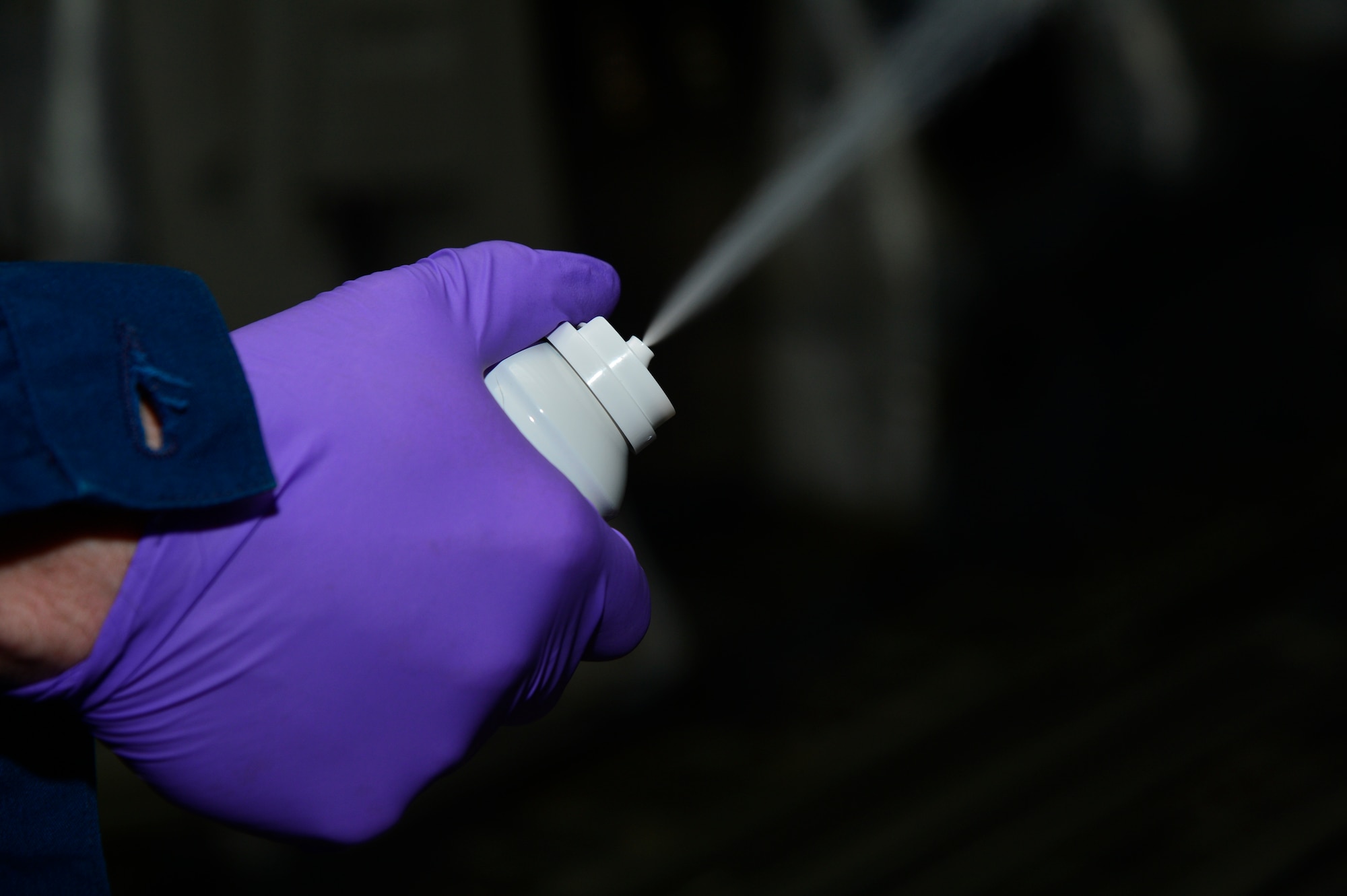 Staff Sgt. Daniel Fink, a 436th Civil Engineer Squadron Pest Management supervisor, treats a C-17 Globemaster III for the Zika virus May 11, 2016, at Dover Air Force Base, Del. A C-17 takes six aerosol cans of Callington 1-Shot to effectively fog the aircraft and treat for mosquitos that are potentially carrying the Zika virus. (U.S. Air Force photo/Senior Airman William Johnson)