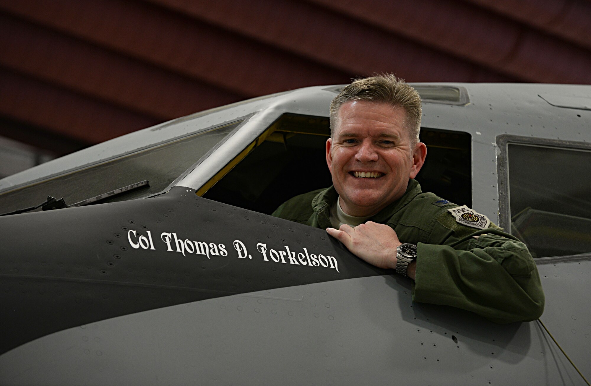 U.S. Air Force Col. Thomas D. Torkelson, 100th Air Refueling Wing commander, unveils his name on the KC-135 Stratotanker that will be the new wing jet May 16, 2016, on RAF Mildenhall, England. The tanker provides aerial refueling capability for the U.S. Air Force. (U.S. Air Force photo by Airman 1st Class Tenley Long/Released)
