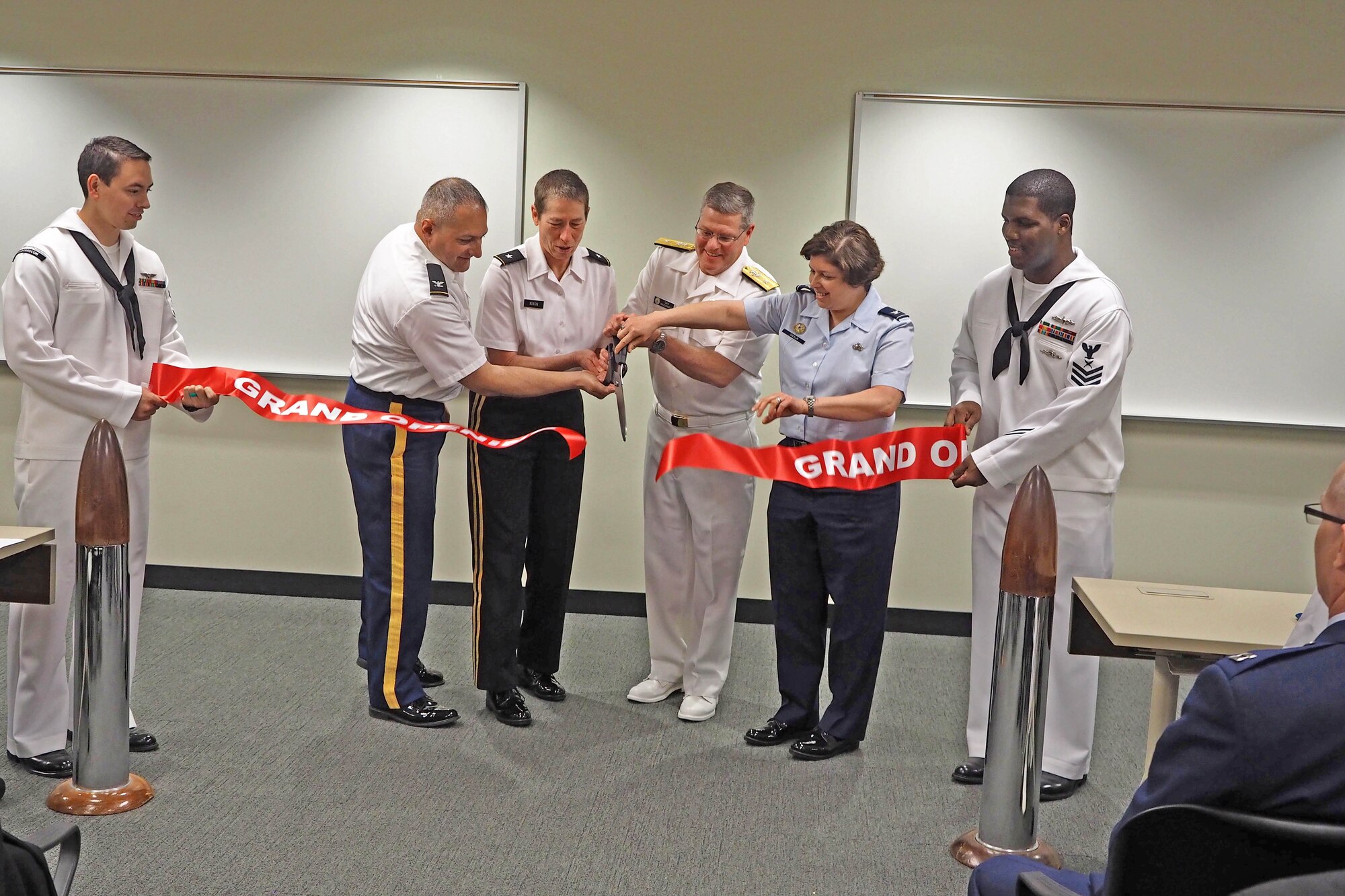 From left, Col. Aram Sarafian, Joint Reserve Intelligence Program; Brig. Gen. Christie Nixon, Military Intelligence Readiness Command; Rear Adm. Daniel MacDonnell, Naval Information Force Reserve commander and Col. Deborah Cricklin, Office of the Secretary of Defense; cut the ceremonial ribbon for the newly renovated Joint Reserve Intelligence Center at the Minneapolis-St. Paul Air Reserve Station May 13. (Air Force Photo/Paul Zadach)       