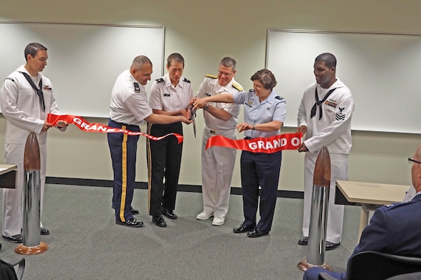 From left, Col. Aram Sarafian, Joint Reserve Intelligence Program; Brig. Gen. Christie Nixon, Military Intelligence Readiness Command; Rear Adm. Daniel MacDonnell, Naval Information Force Reserve commander and Col. Deborah Cricklin, Office of the Secretary of Defense; cut the ceremonial ribbon for the newly renovated Joint Reserve Intelligence Center at the Minneapolis-St. Paul Air Reserve Station May 13. (Air Force Photo/Paul Zadach)       