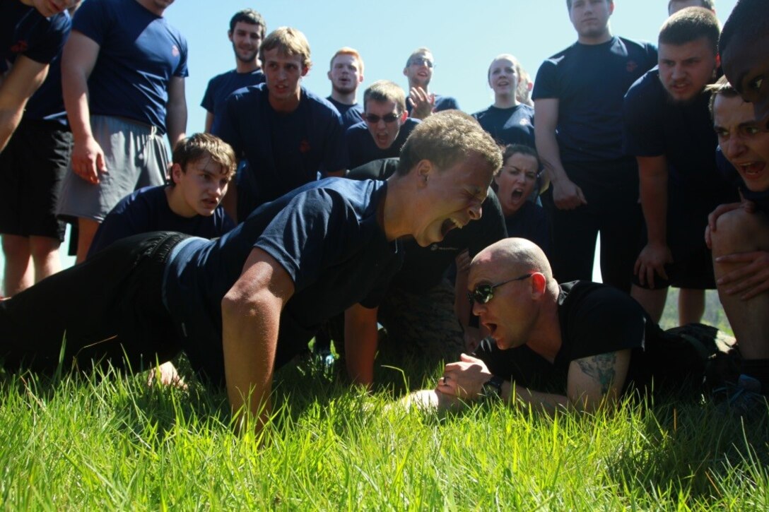 U.S. Marine Corps Poolees with Recruiting Sub-station Beckley motivate Micah Daniels, a junior at Woodrow Wilson High School, during a pushup competition as part of the field meet portion of Recruiting Station Charleston’s Statewide Function April 16, 2016. The bi-annual event brought poolees from across West Virginia, Virginia, Tennessee and Kentucky together to participate in an Initial Strength Test and compete in a field meet. (U.S. Marine Corps photo by Sgt. Caitlin Brink/released)