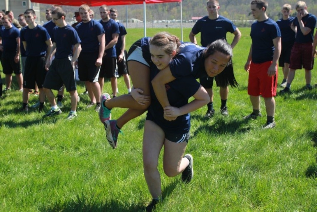 U.S. Marine Corps Poolee Lashonda Stone, a senior at East Carter High School in Grayson, Kentucky, carries Poolee Taley Arms, a graduate of Spring Valley High School in Huntington, West Virginia, as part of the field meet portion of Recruiting Station Charleston’s Statewide Function April 16, 2016. The bi-annual event brought poolees from across West Virginia, Virginia, Tennessee and Kentucky together to participate in an Initial Strength Test and compete in a field meet. (U.S. Marine Corps photo by Sgt. Caitlin Brink/released)