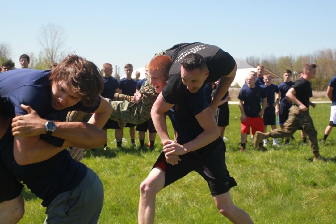 U.S. Marine Corps Poolee Joshua Warshaw, a Senior at Oak Hill High School in Oak Hill, West Virginia, races carrying Sgt. Ryan Wagner, a recruiter with Recruiting Sub-station Beckley, as part of the field meet portion of Recruiting Station Charleston’s Statewide Function April 16, 2016. The bi-annual event brought poolees from across West Virginia, Virginia, Tennessee and Kentucky together to participate in an Initial Strength Test and compete in a field meet. (U.S. Marine Corps photo by Sgt. Caitlin Brink/released)