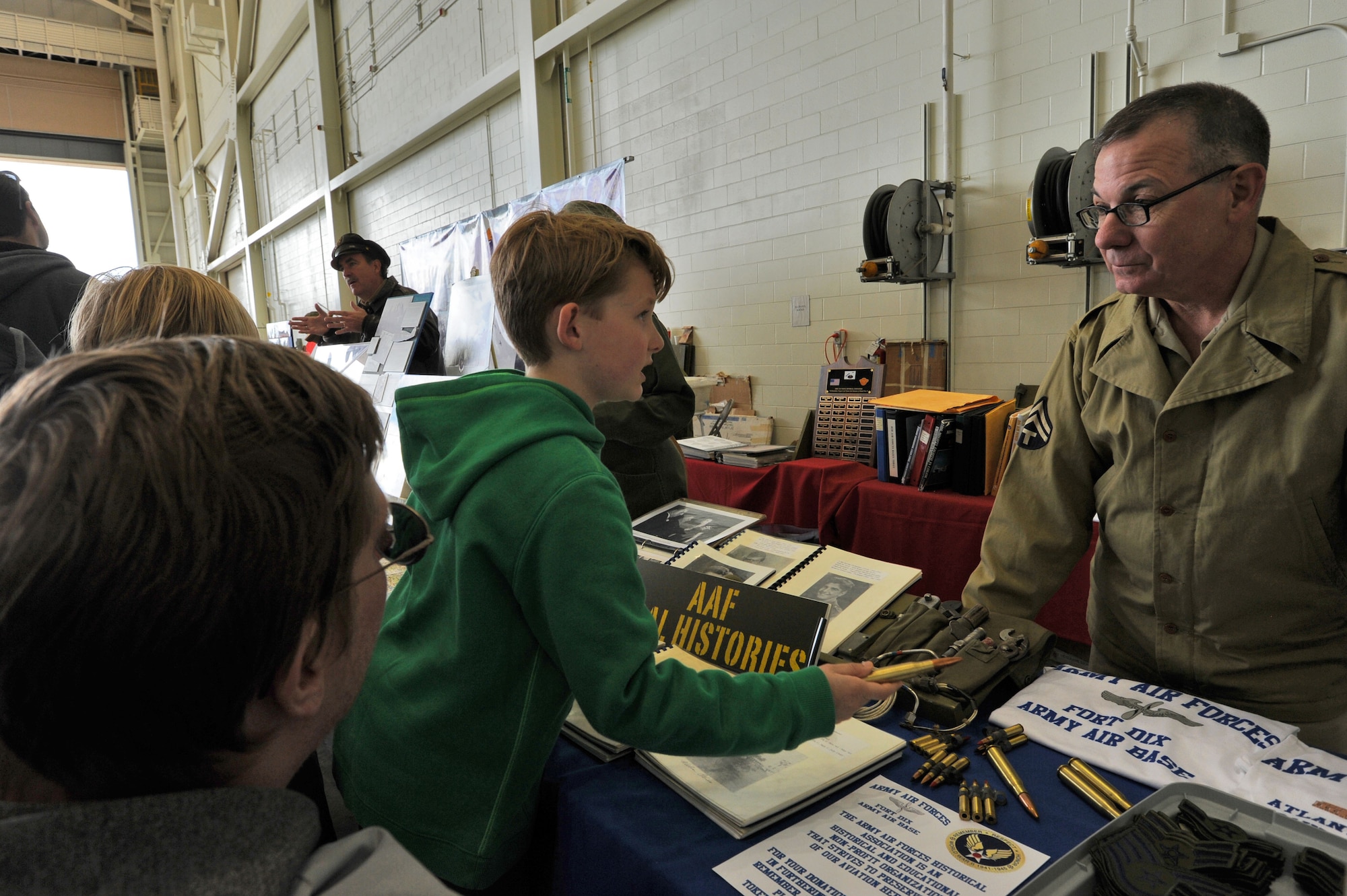 Master Sgt. Patrick Ragosta, a historian with the 514th Air Mobility Wing, here, shares his love of history with Power in the Pine 2016 spectators. The crowd total reached 375,000 for the two-day Air Show featuring aerial demonstrations, static displays and interactive activities for everyone to enjoy.