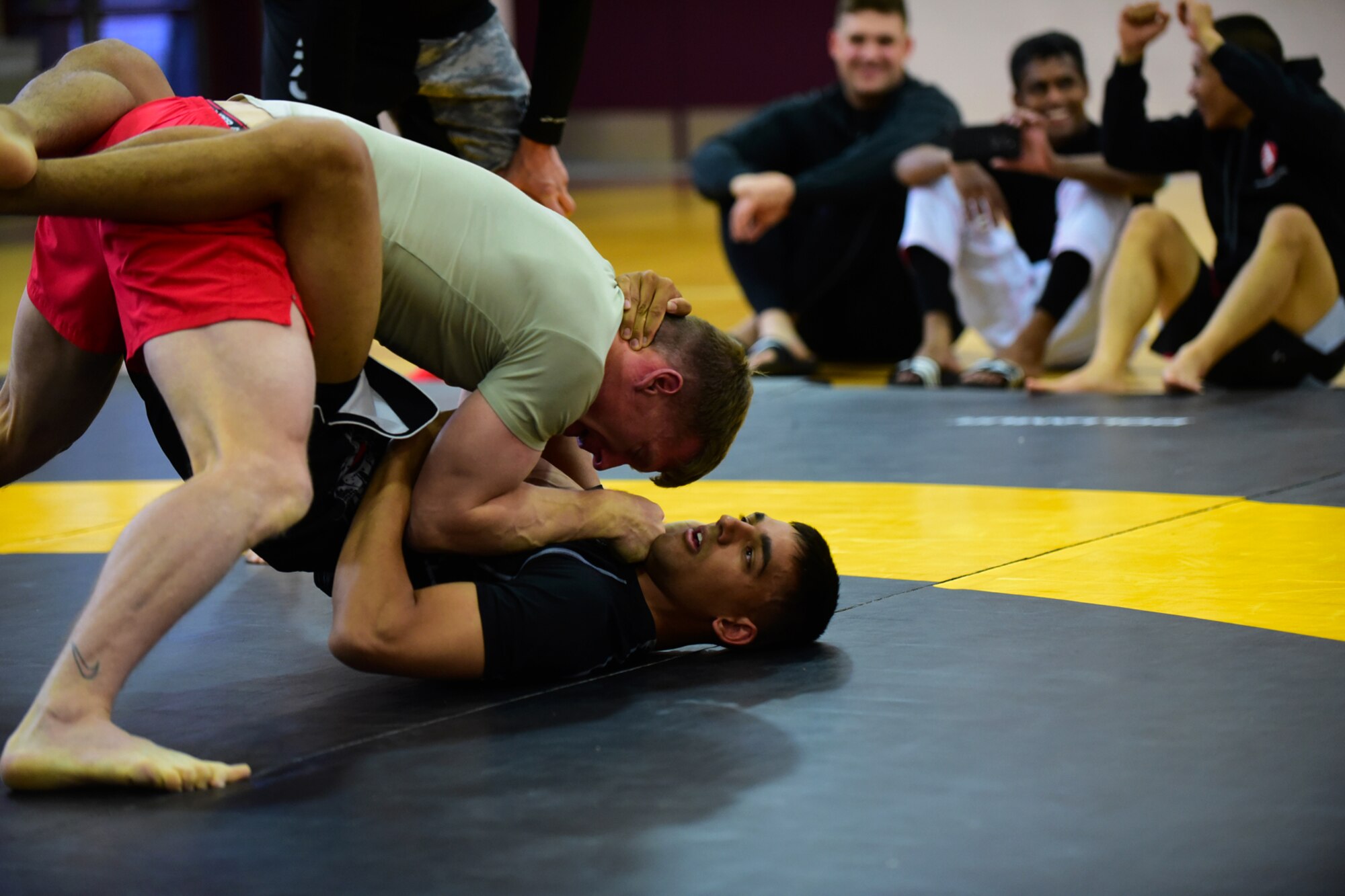 PETERSON AIR FORCE BASE, Colo. - Combatants go to the mat during the National Police Week Ground Combatives Tournament held on Peterson Air Force Base, Colo., May 17, 2016. Participants fought using ground combat styles such as jujitsu, wrestling, ninjutsu and sambo.  (U.S. Air Force photo by Staff Sgt. Amber Grimm)