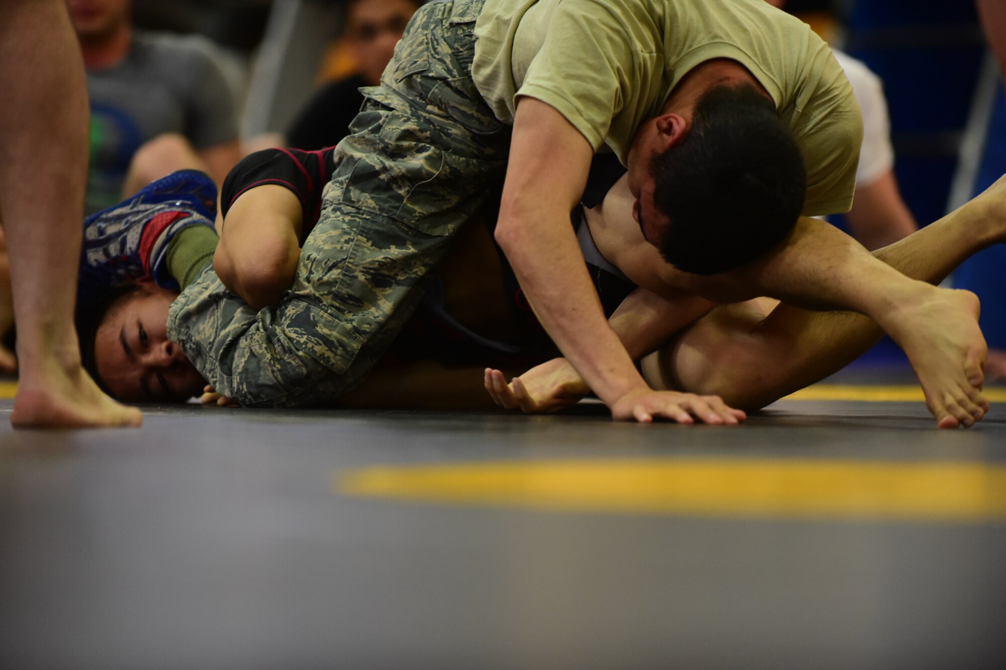 PETERSON AIR FORCE BASE, Colo. – Combatants grapple for position during the National Police Week Ground Combatives Tournament held on Peterson Air Force Base, Colo., May 17, 2016. Matches could last up to five minutes with the winner decided by either submission or judge’s ruling. (U.S. Air Force photo by Staff Sgt. Amber Grimm)